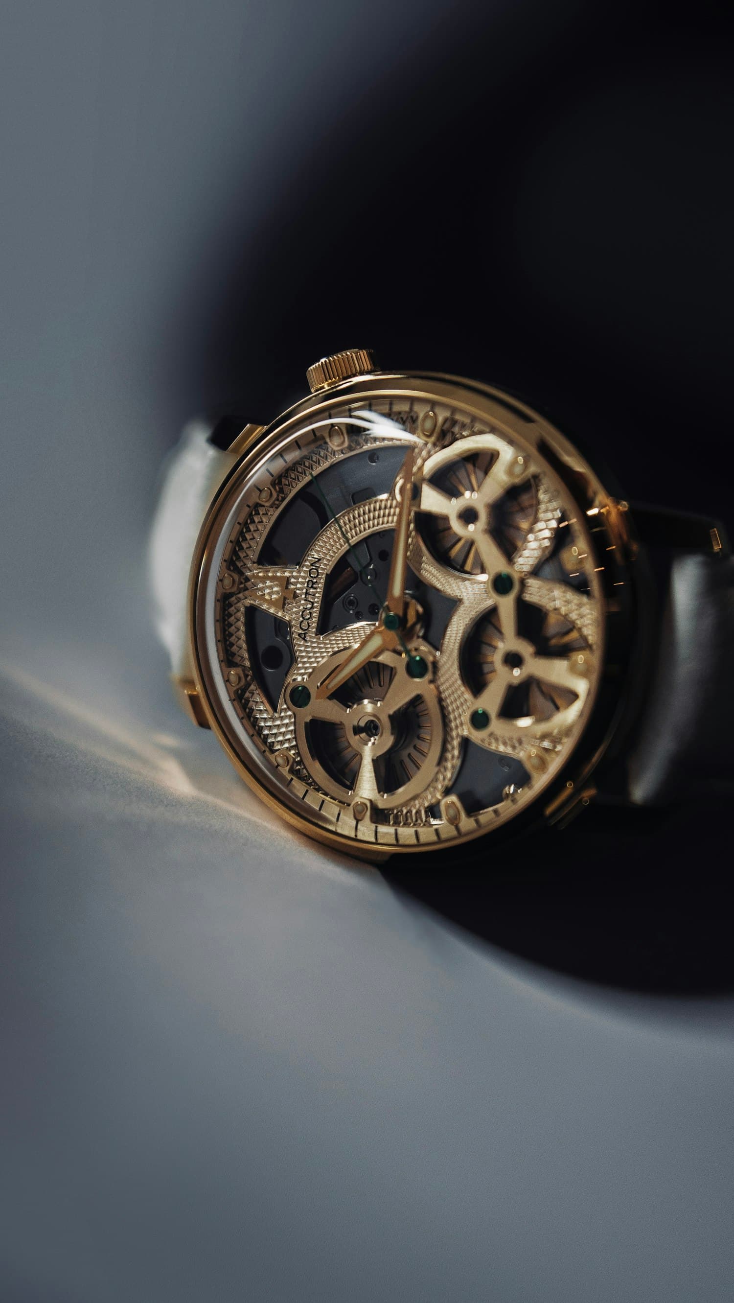 Exposed golden watch movement, gears and bridges