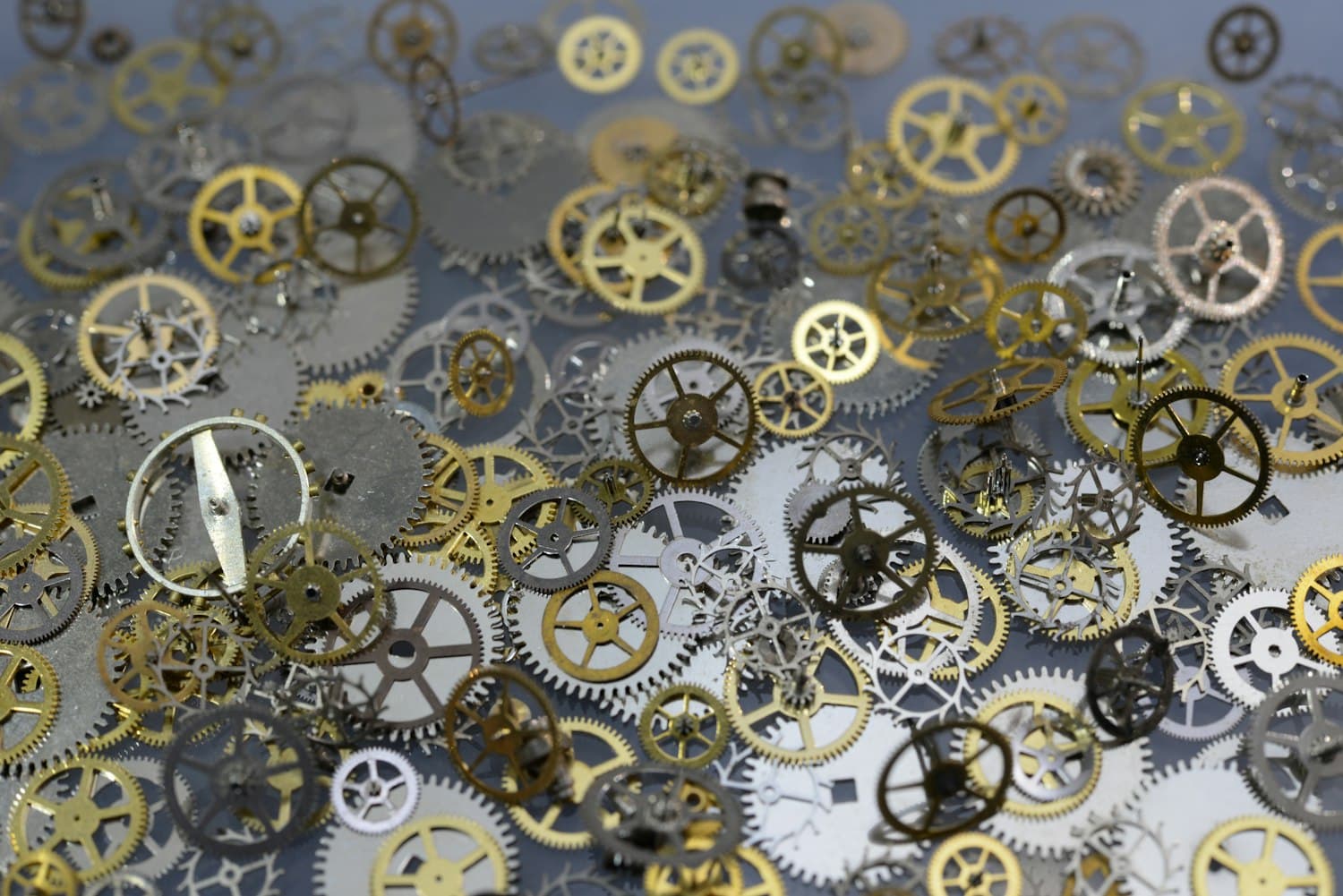Macro of titanium-toned watch cogs and wheels