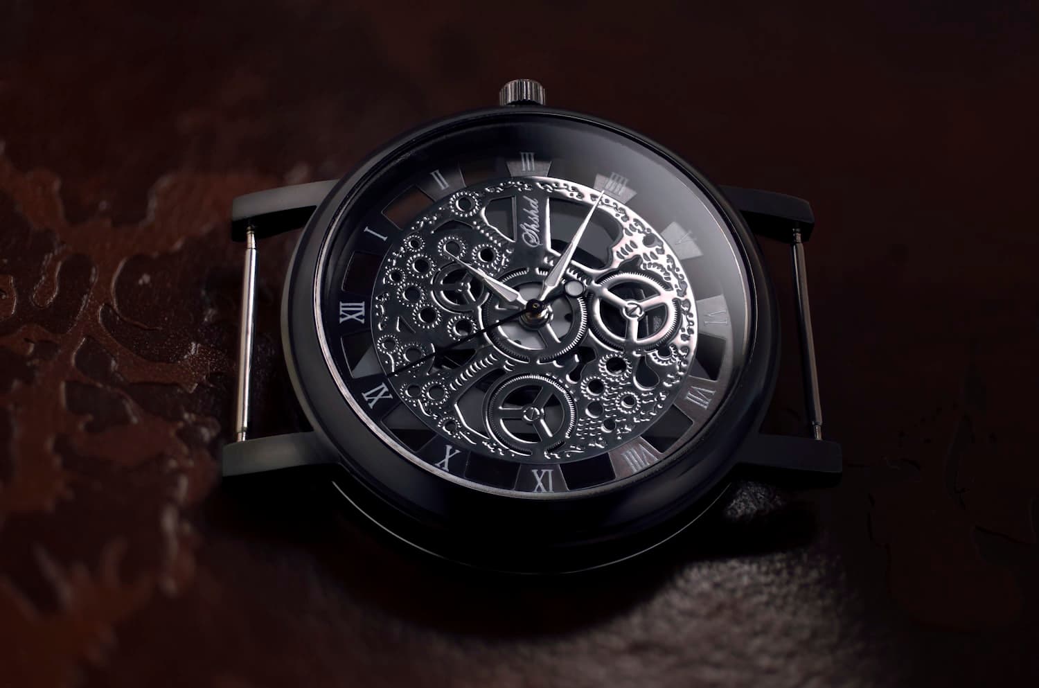 Skeleton watch with roman numerals in low light